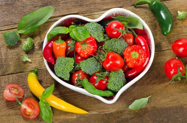 Vegetables in heart shape bowl — Stock Photo, Image