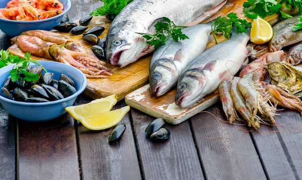 Raw seafood on wooden board. — Stock Photo, Image