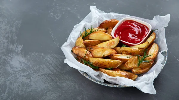 Baked country style potato wedges with herbs and sauce. Copy space