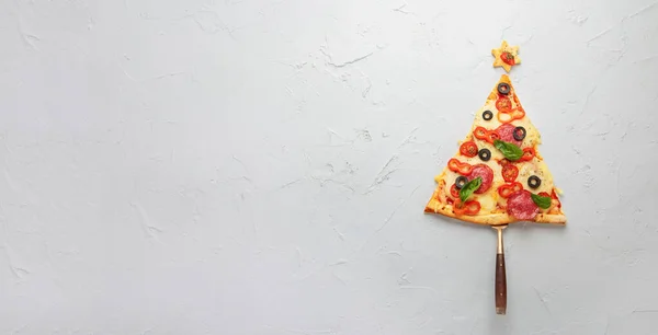 Piece of pizza set like christmas tree. Christmas and New year concept. Top view, copy space