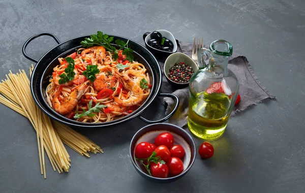 Pasta with shrimps in tomato sauce. Italian cuisine.