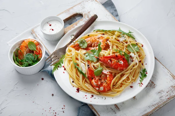 Pasta with shrimps in white sauce. Italian cuisine.