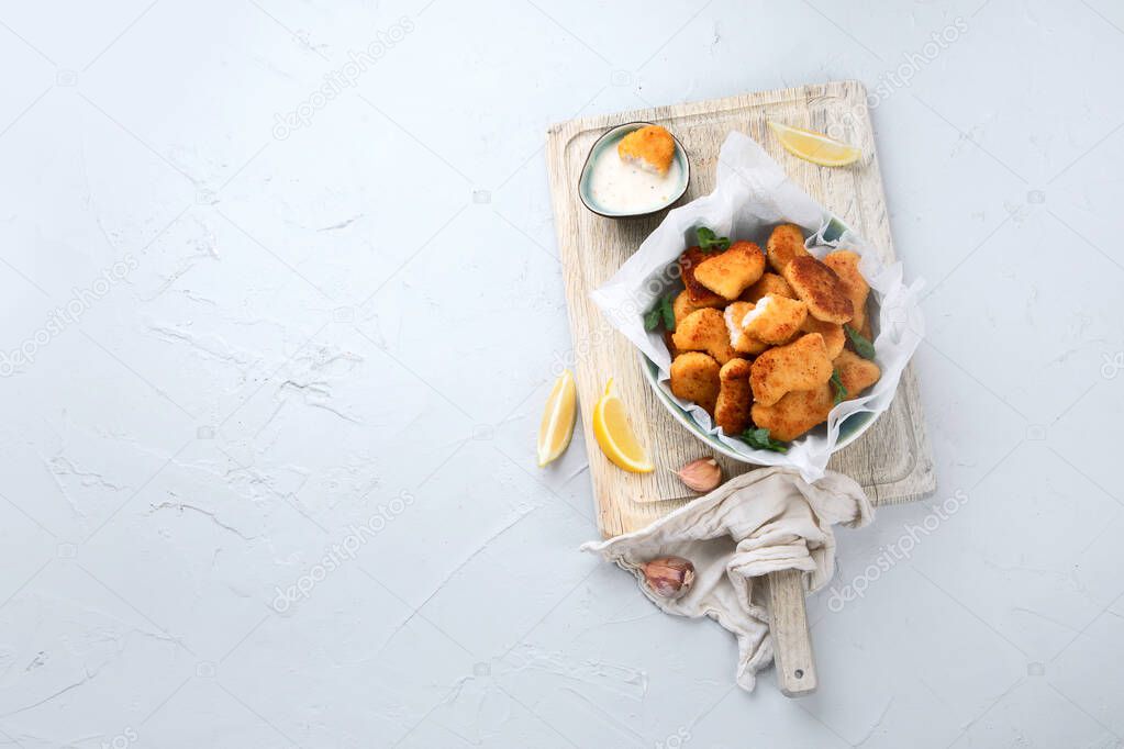 Fried crispy chicken nuggets with ketchup on wooden board. Top view, copy space