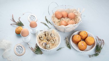 Yumurtalı Paskalya kompozisyonu ve açık gri arka planda renkli tatlılar. Mevsimlik tatil kavramı. 