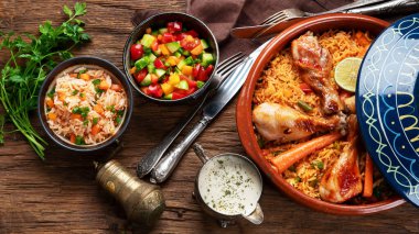 Tajin tavuk yahnisi, pilav ve sebzeli sos ve salata. Doğulu öğle yemeği konsepti. Topv görünümü