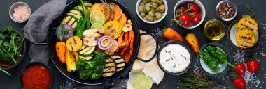 Izgara sebzeler, siyah arka planda dökme demir tavada. Izgara menüsü. Üst manzara, panorama