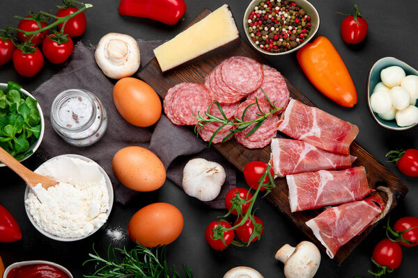 Italian pizza preparation. Variety of traditional cooking ingredients. Homemade delicious recipe concept. Top view