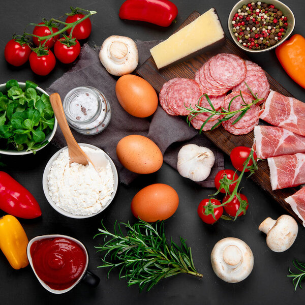 Italian pizza preparation. Variety of traditional cooking ingredients. Homemade delicious recipe concept. Top view, copy space