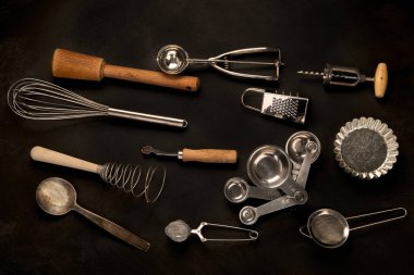 Set of kitchen utensils on black background. Tools for cooking. Top view