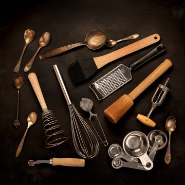 Set of kitchen utensils on black background. Tools for cooking. Top view