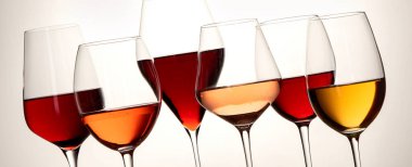 Red, rose and white wine in glasses on white background. Panorama, banner 