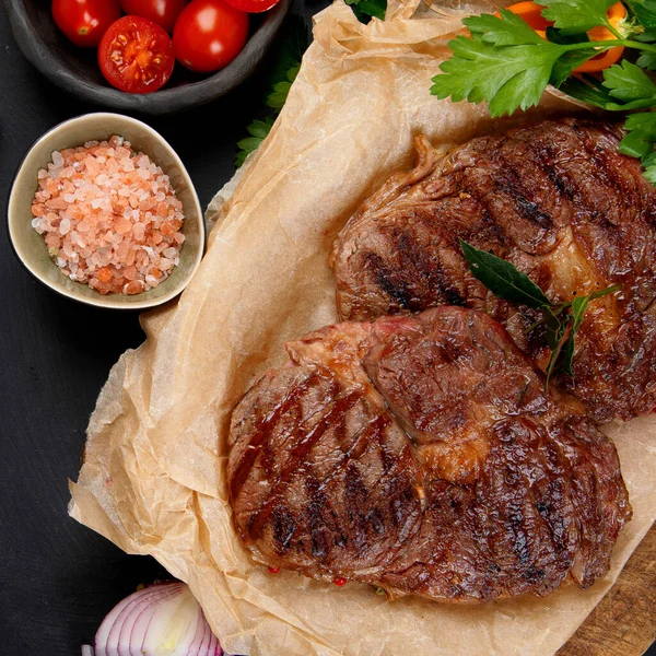 Delicious Prepared Meat Steaks Seasoning Herbs Dark Background Geilled Food — Foto Stock