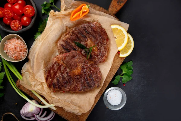 Delicious Prepared Meat Steaks Seasoning Herbs Dark Background Geilled Food — Zdjęcie stockowe