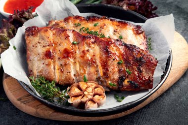 Koyu gri arka planda abur cubur ve sos ile kızarmış pirzola. Gurme yemek pişirme kavramı. Boşluğu kopyala