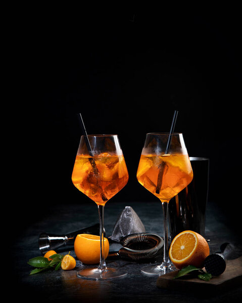 Aperol spritz cocktail served on dark background. Classic drink menu concept. Front view