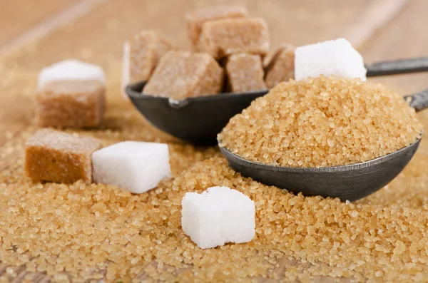 Sugar on wooden table — Stock Photo, Image