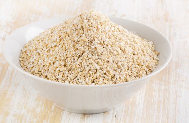 Healthy Oat bran on a  wooden table clipart