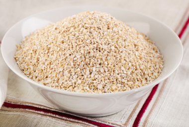 Oat bran in a white bowl clipart