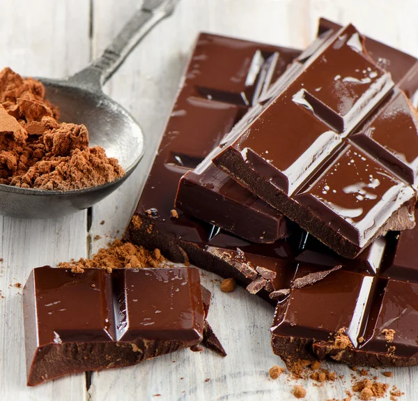 Cocoa powder and broken chocolate bar — Stock Photo, Image