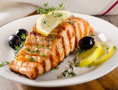 Salmon with lemon, olives and thyme clipart