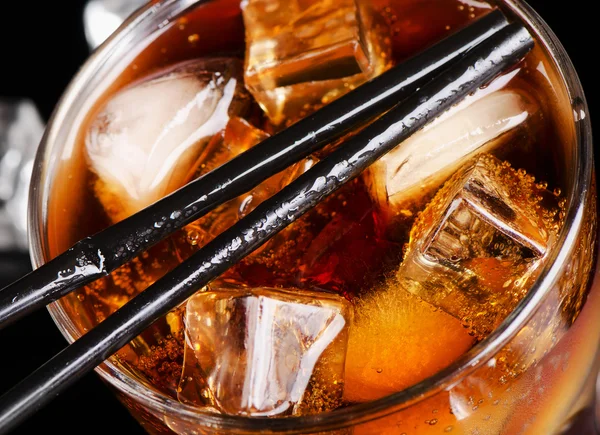 Glass of cola with ice cube — Stock Photo, Image