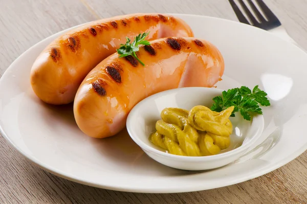 Roasted sausages with mustard sauce — Stock Photo, Image