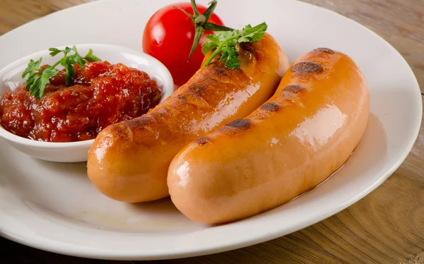 Grilled sausages with tomato sauce — Stock Photo, Image