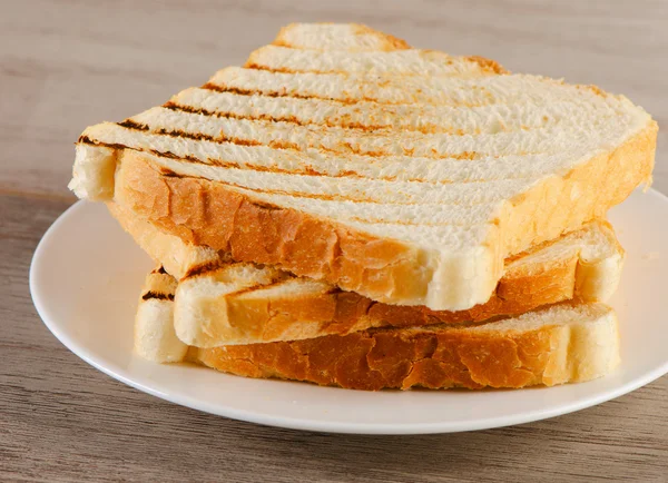 Sneetjes toast brood op een witte plaat — Stockfoto