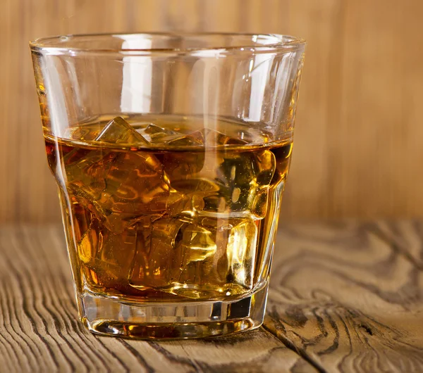 Glass of whiskey with ice — Stock Photo, Image