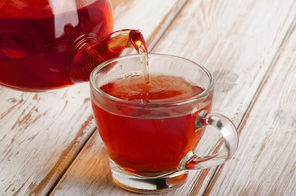 Tea pouring into glass cup — Stock Photo, Image