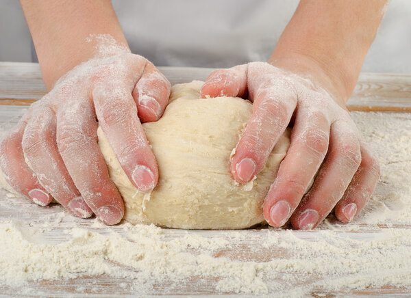 Hands kneading dough