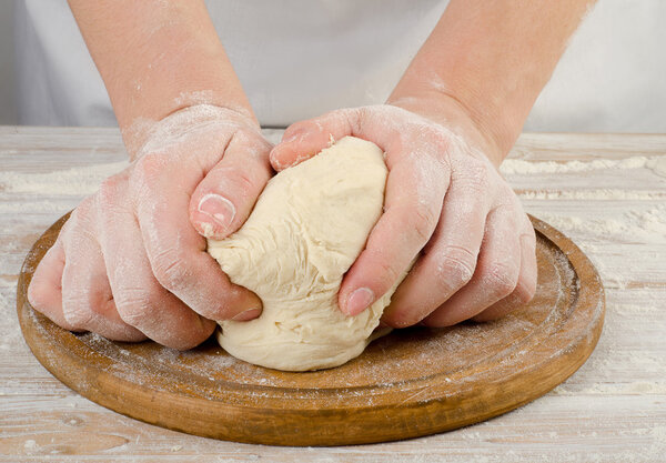 Hands preparing dough