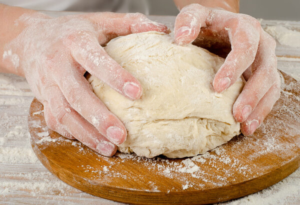 Hands preparing dough