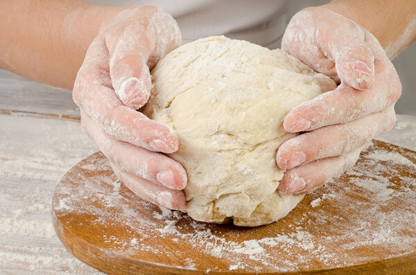 Hands preparing dough