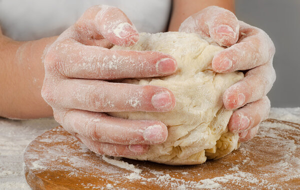 Hands preparing dough