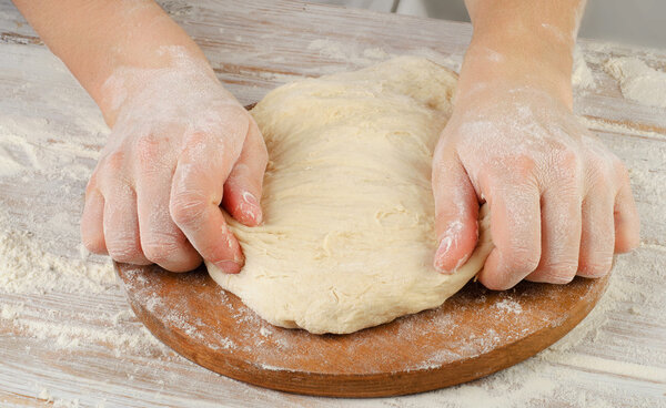 Hands preparing dough