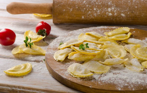 Cheese ravioli on wooden board — Stock Photo, Image