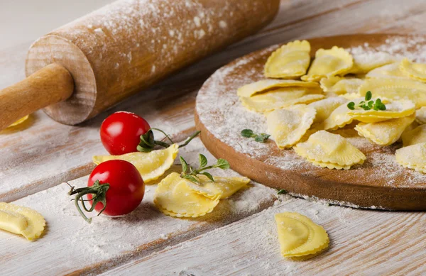 Cheese ravioli on wooden board — Stock Photo, Image