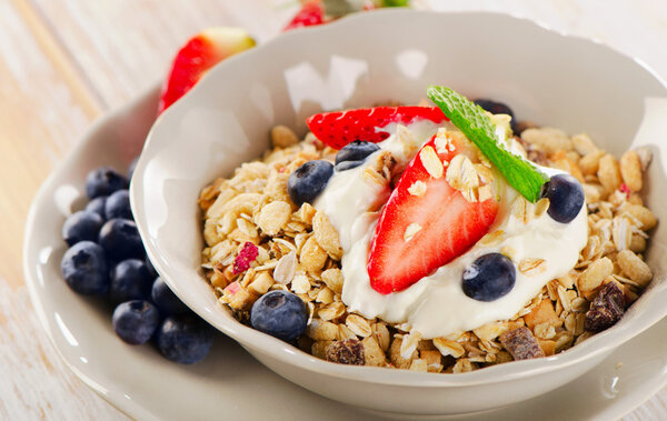 Healthy Breakfast with  berries, yogurt and  muesli.
