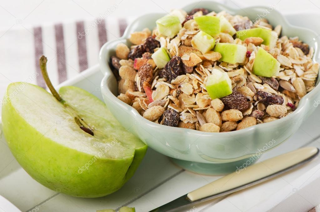 Healthy bowl of muesli and  apple