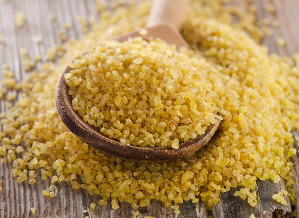 Bulgur in  wooden spoon — Stock Photo, Image