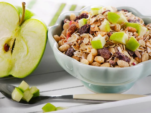 Bowl of muesli and apple — Stock Photo, Image