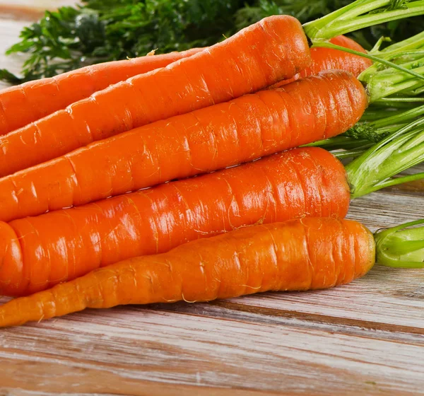 Fresh carrots with green leaves — Stock Photo, Image