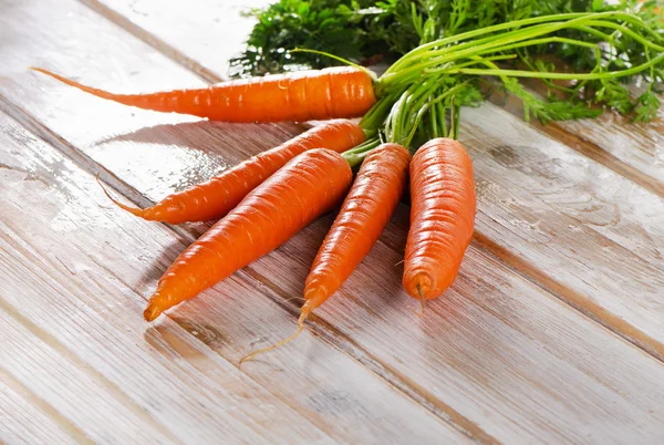 Fresh carrots with green leaves — Stock Photo, Image