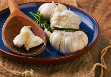 Raw Organic garlic  on  a plate.  clipart