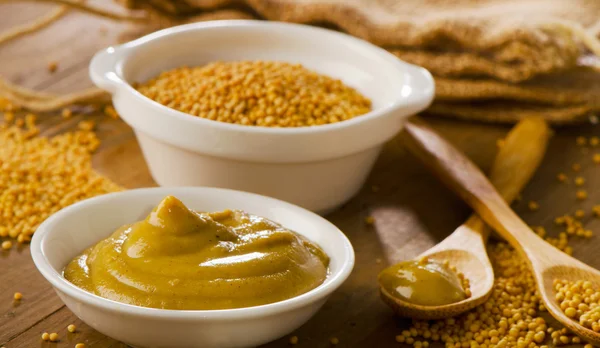 Mustard  on   old  wooden table. Stock Image