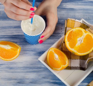 Woman hands holding a cup of milk .