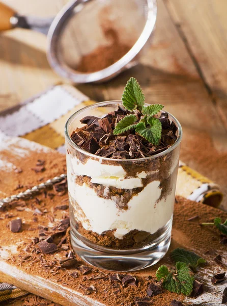 Tiramisu cake with a fresh mint in glass. — Stock Photo, Image