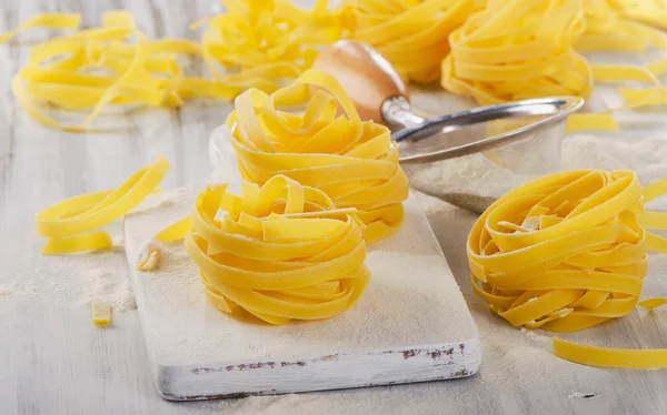 Uncooked Pasta   on  cutting board — Stock Photo, Image