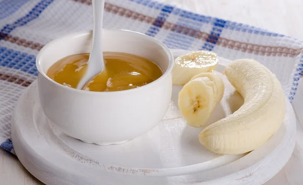 Dětská výživa - banány pyré v bílé misce. — Stock fotografie